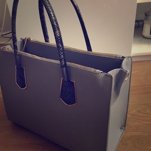 Grey gold zippered snake skinned handle bag